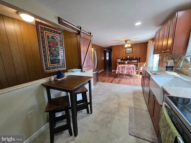 a kitchen with stainless steel appliances granite countertop wooden cabinets a stove top oven a sink and dishwasher