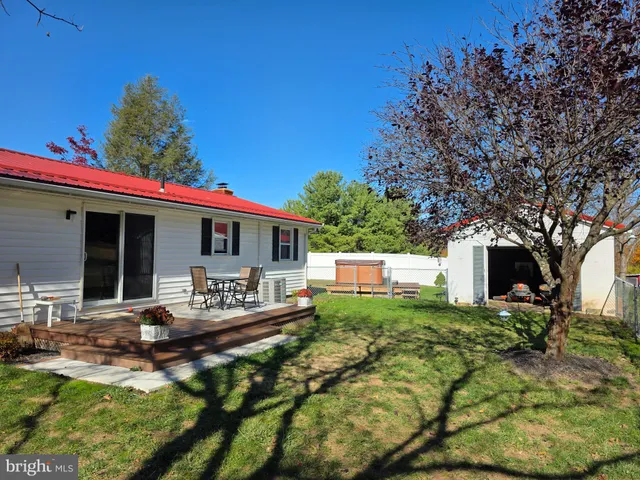 a view of a house with a yard and sitting area