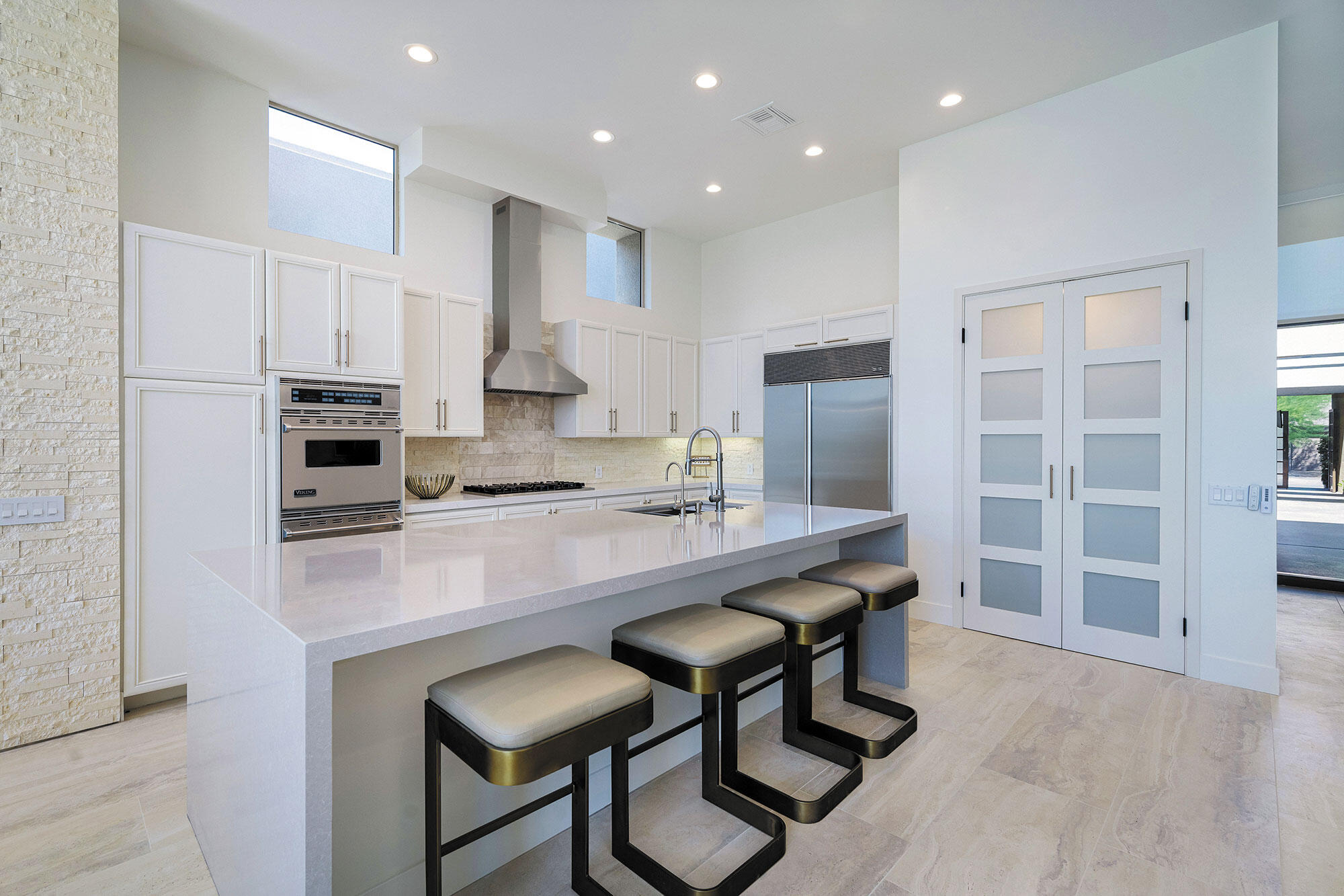 178 Wikil Place Palm Desert, CA 92260 - Photo 4 of 15 a kitchen with stainless steel appliances granite countertop a table chairs sink refrigerator and cabinets