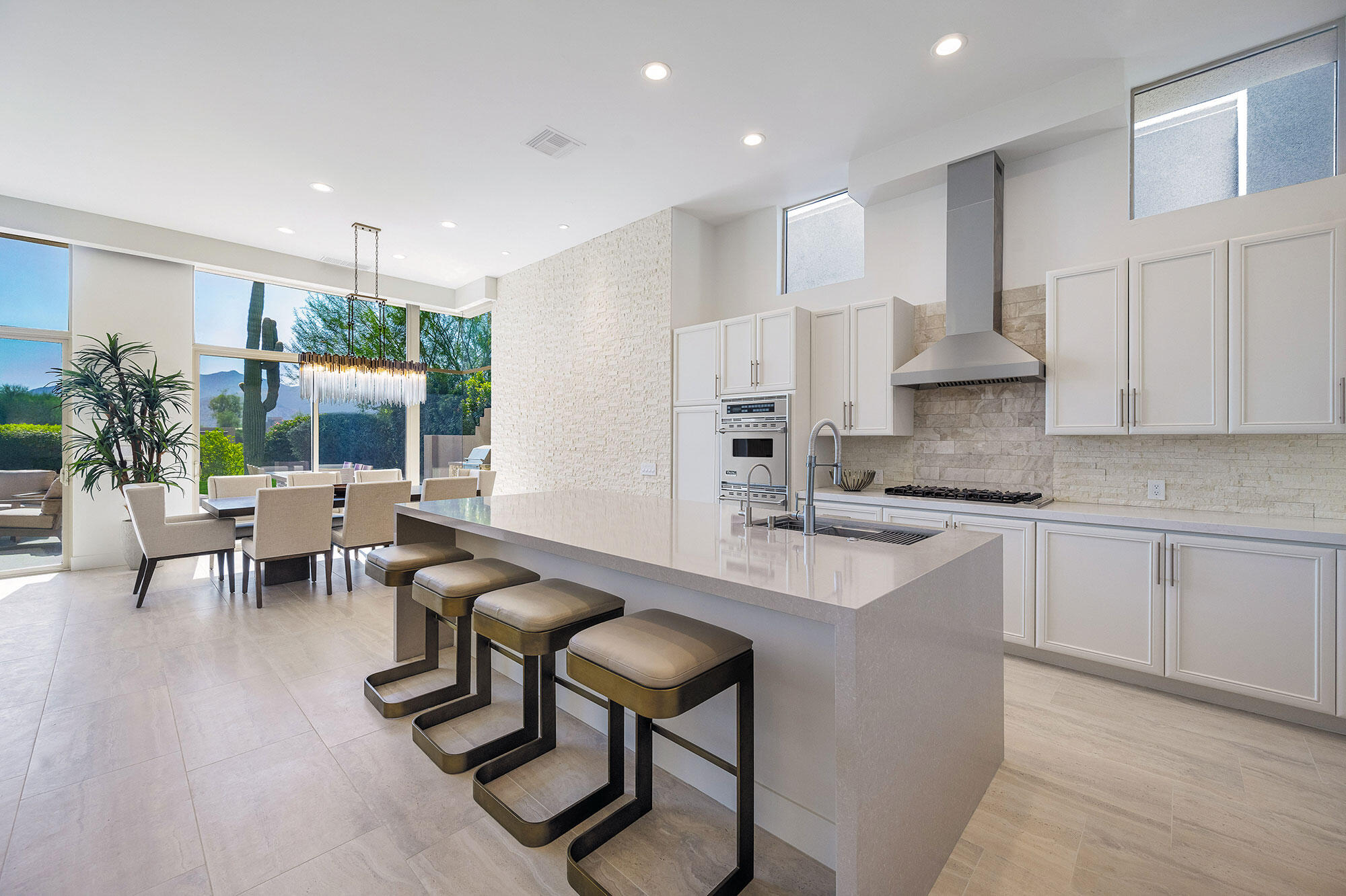 178 Wikil Place Palm Desert, CA 92260 - Photo 6 of 15 a kitchen with stainless steel appliances granite countertop table chairs sink and cabinets