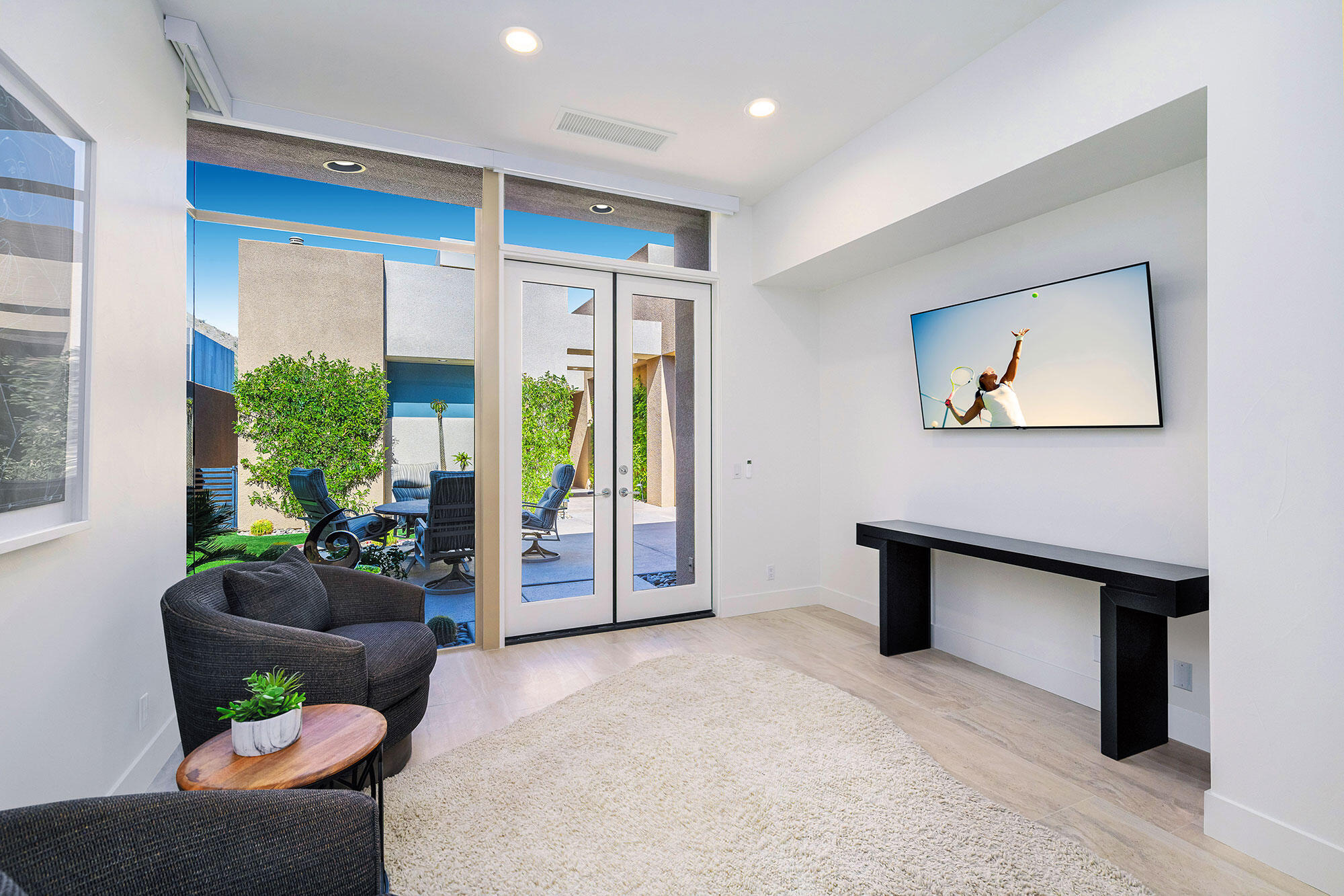 178 Wikil Place Palm Desert, CA 92260 - Photo 8 of 15 a living room with furniture a potted plant and a large window