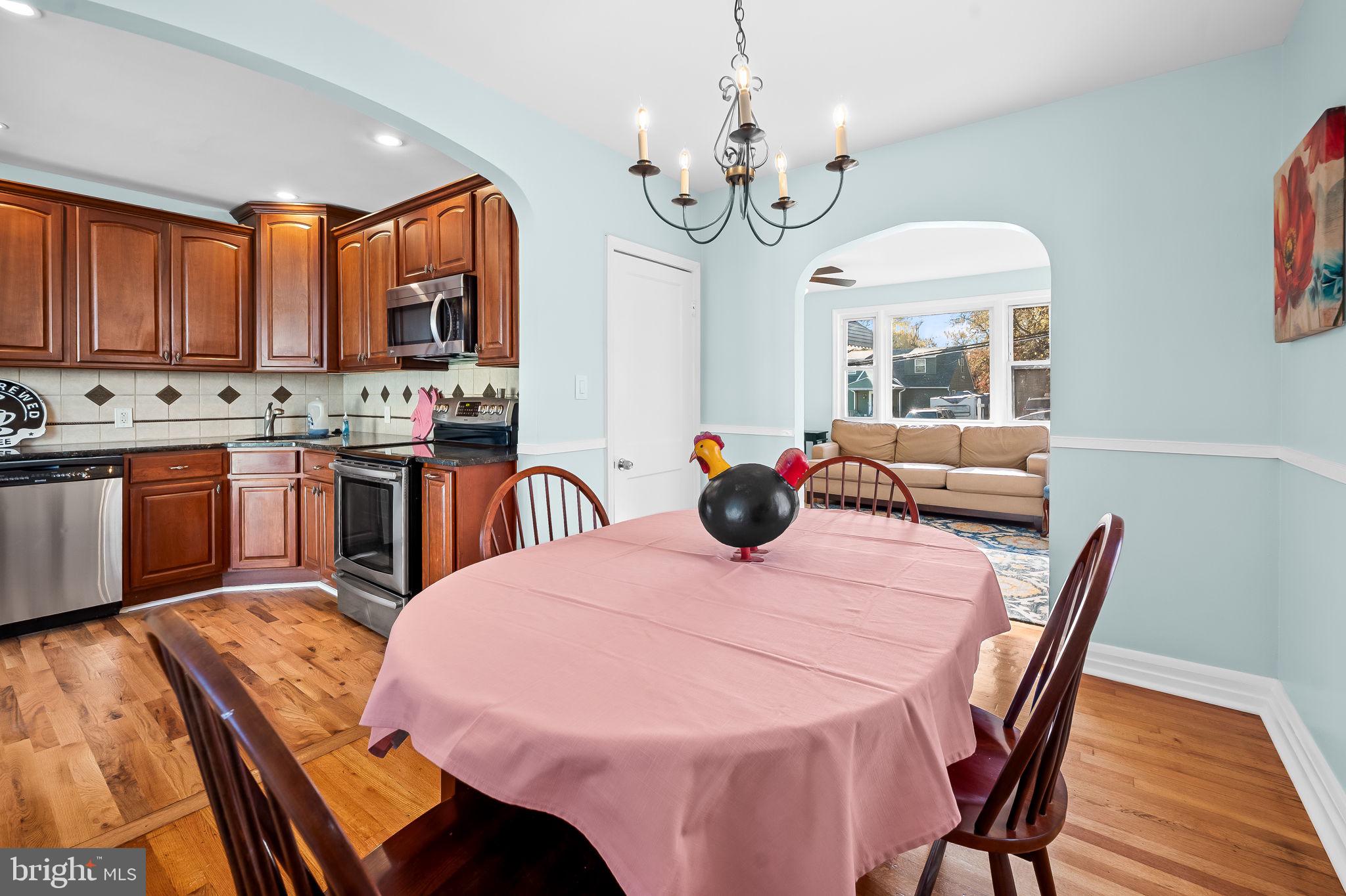 7922 Underhill Road Rosedale, MD 21237 - Photo 15 of 41 a view of a dining room with furniture a chandelier and wooden floor