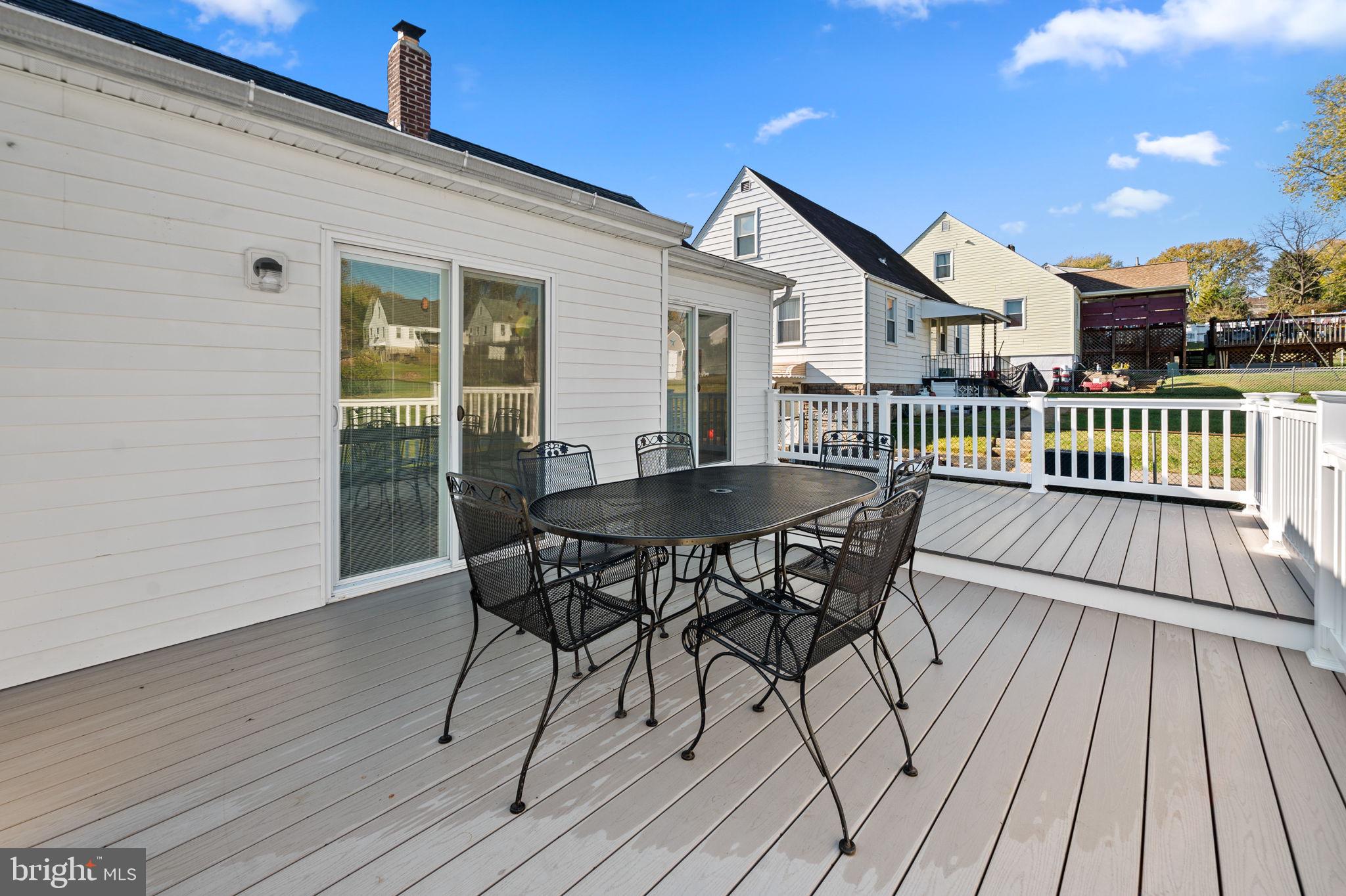 7922 Underhill Road Rosedale, MD 21237 - Photo 17 of 41 a view of a roof deck with table and chairs and wooden floor