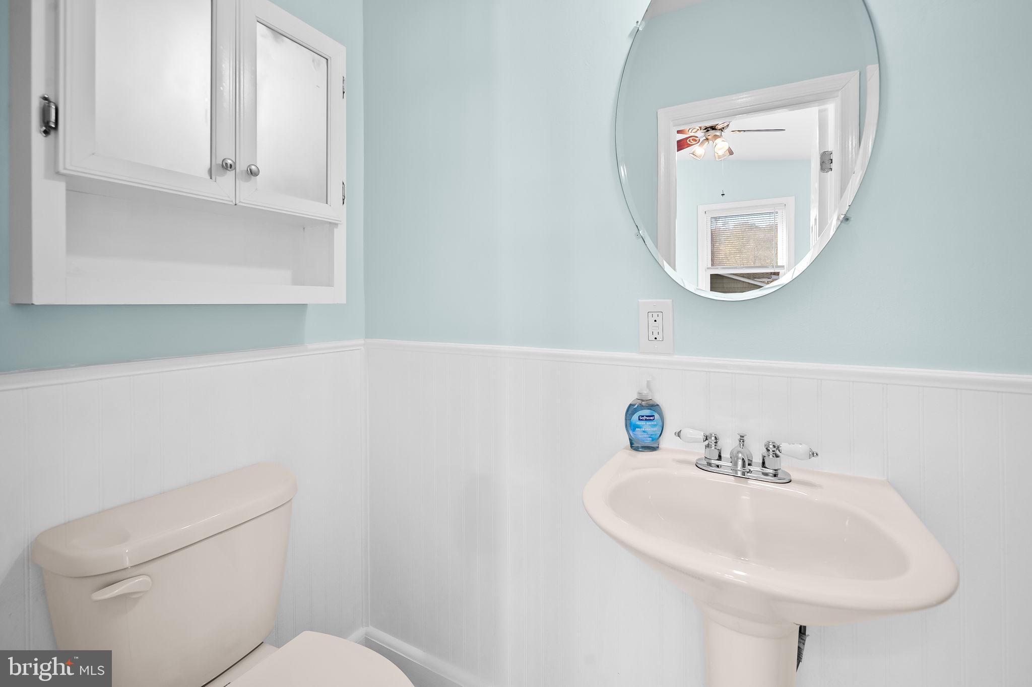 7922 Underhill Road Rosedale, MD 21237 - Photo 28 of 41 a bathroom with a sink a mirror and a toilet