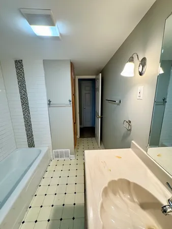 a bedroom with a bed and a mirror
