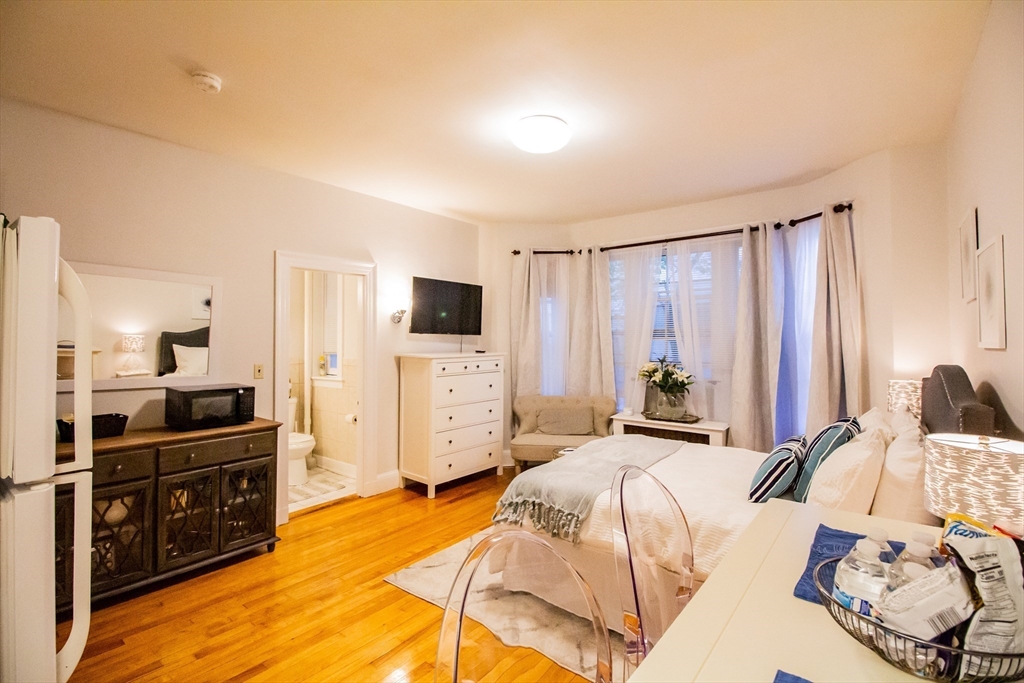 1253 Beacon Street, Unit A3 Brookline, MA 02446 - Photo 8 of 10 a bed room with a bed and a tv