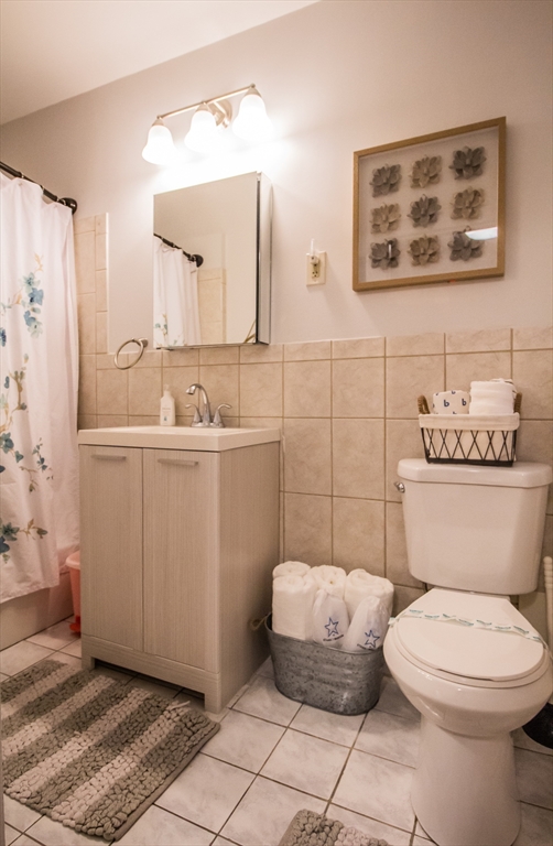 1253 Beacon Street, Unit A3 Brookline, MA 02446 - Photo 9 of 10 a bathroom with a toilet sink and mirror