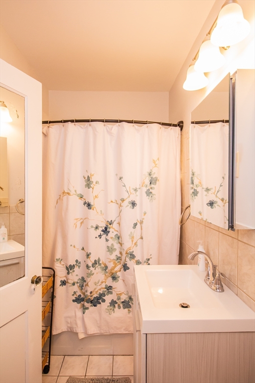 1253 Beacon Street, Unit A3 Brookline, MA 02446 - Photo 10 of 10 a bathroom with a sink and a shower curtain