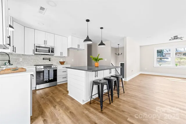 a kitchen with a wooden floor and white appliances