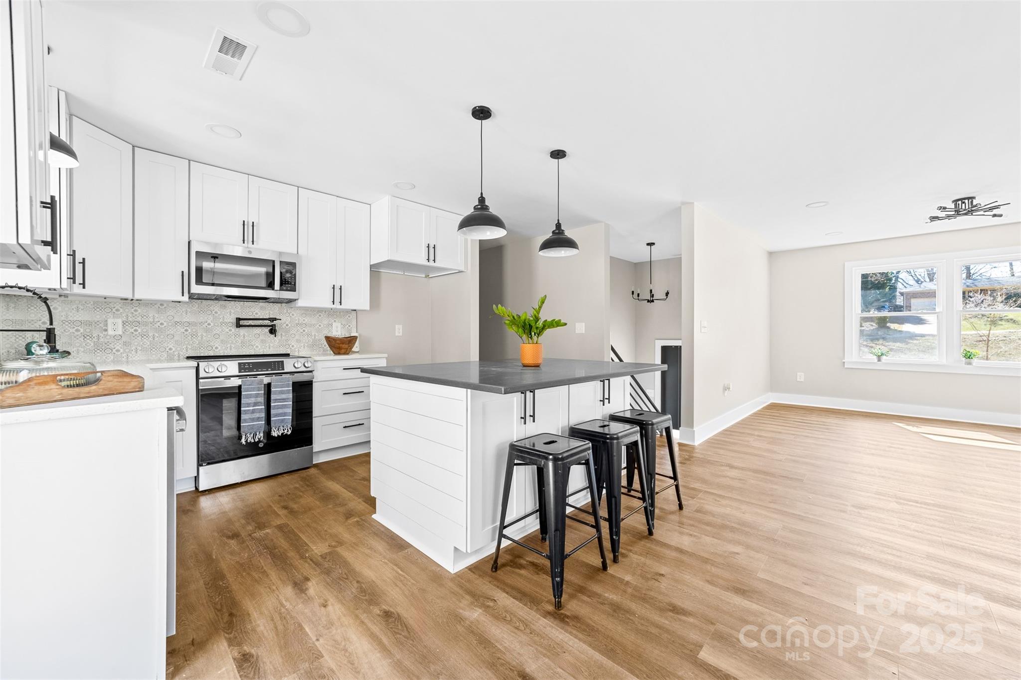 a kitchen with a wooden floor and white appliances