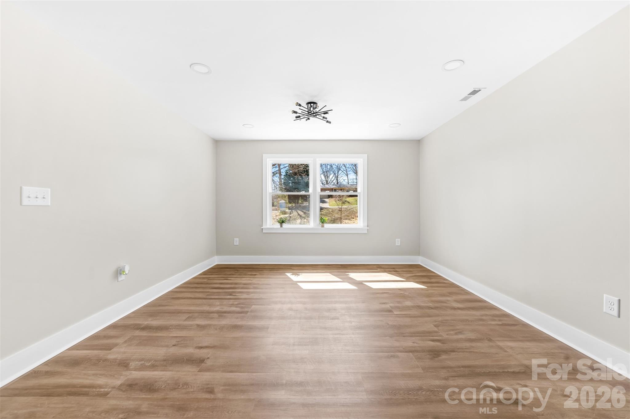 205 Redding Road Stanley, NC 28164 - Photo 16 of 34 an empty room with wooden floor and windows