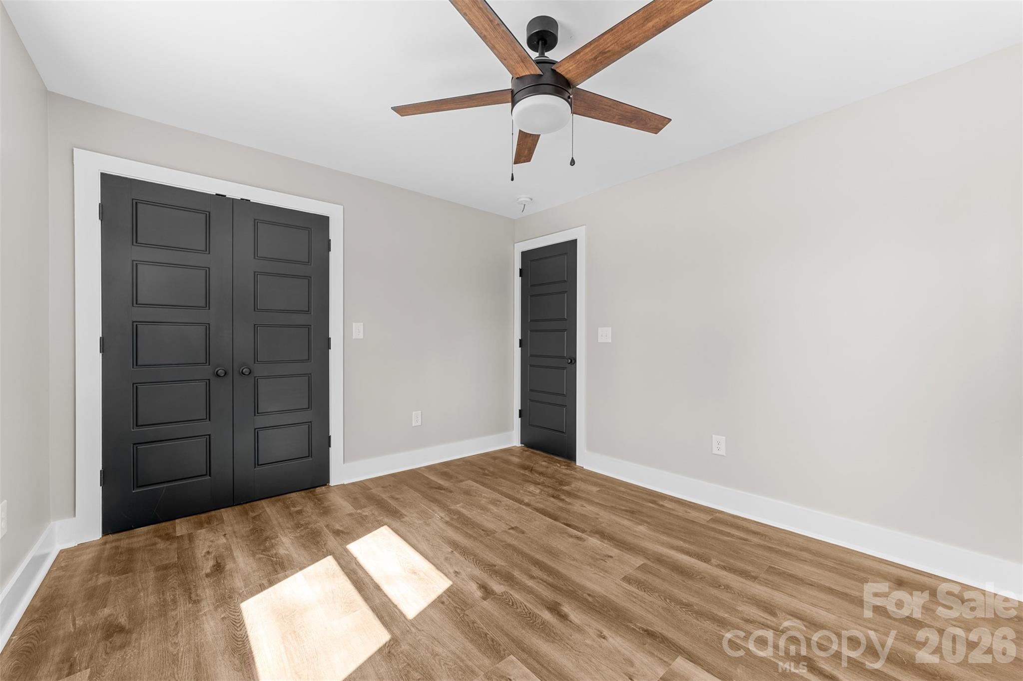 205 Redding Road Stanley, NC 28164 - Photo 19 of 34 a view of a livingroom with a ceiling fan and wooden floor