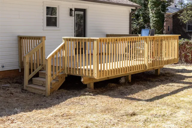 a view of a yard with wooden fence