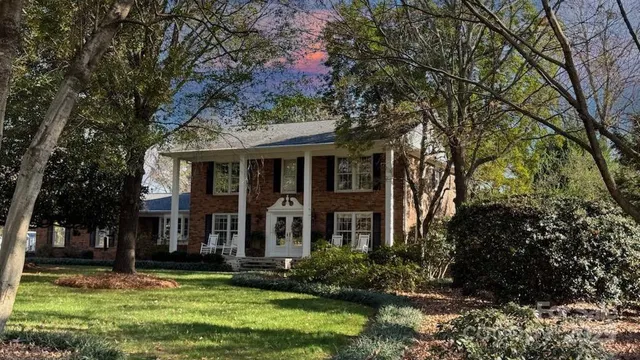 a view of a dining room with furniture and a chandelier