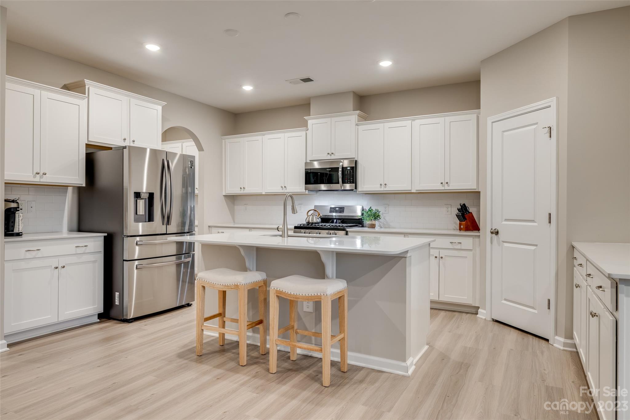 1656 Corwin Bend Road Tega Cay, SC 29708 - Photo 15 of 47 a kitchen with white cabinets and stainless steel appliances