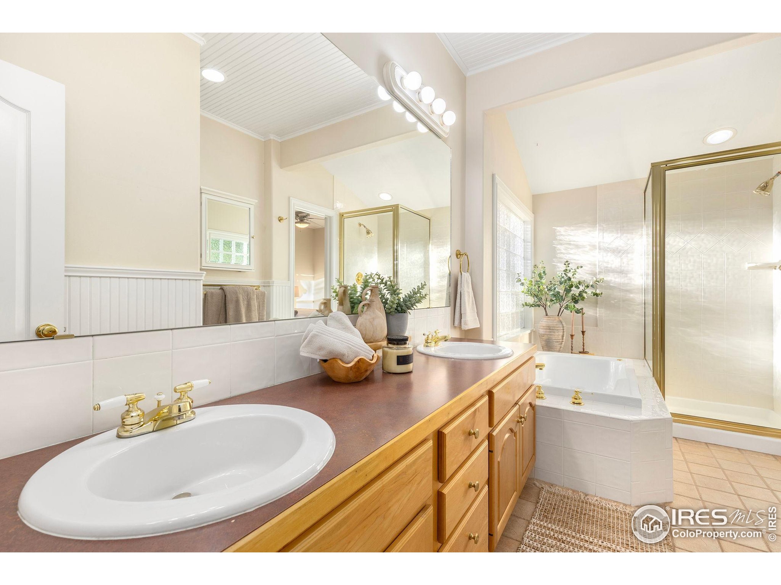 961 5th Street Berthoud, CO 80513 - Photo 12 of 35 a bathroom with a tub sink and mirror