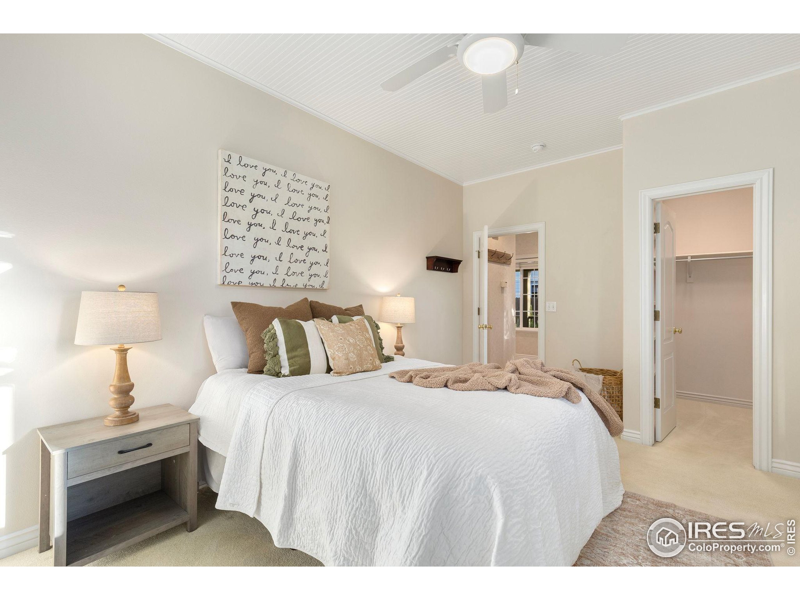 961 5th Street Berthoud, CO 80513 - Photo 19 of 35 a bedroom with a bed and a lamp