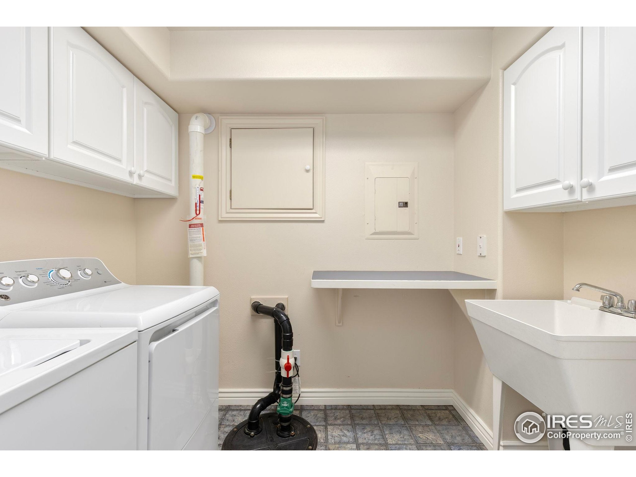 961 5th Street Berthoud, CO 80513 - Photo 21 of 35 a utility room with cabinets washer and dryer