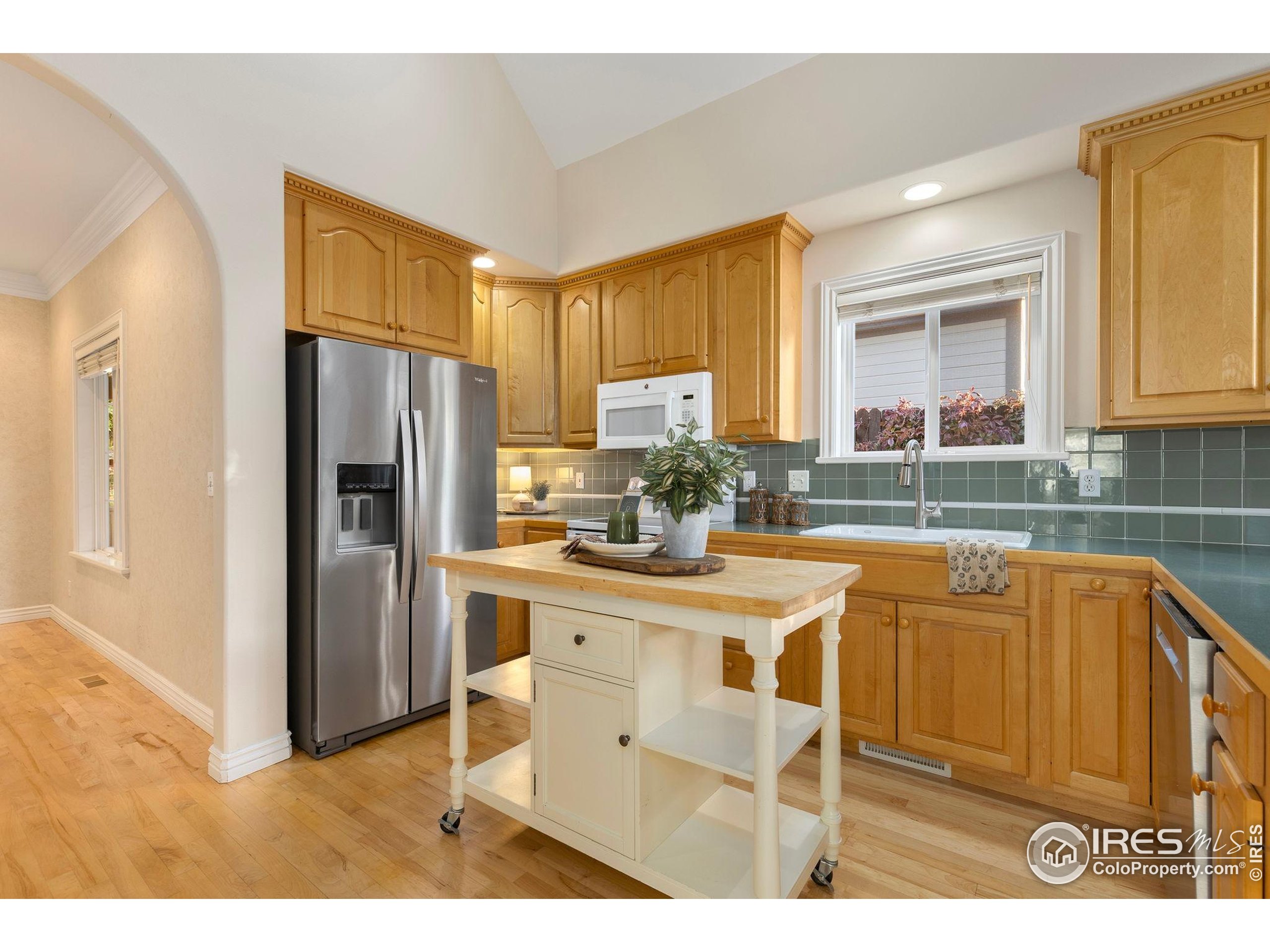 961 5th Street Berthoud, CO 80513 - Photo 7 of 35 a kitchen with stainless steel appliances granite countertop a refrigerator a stove and a sink