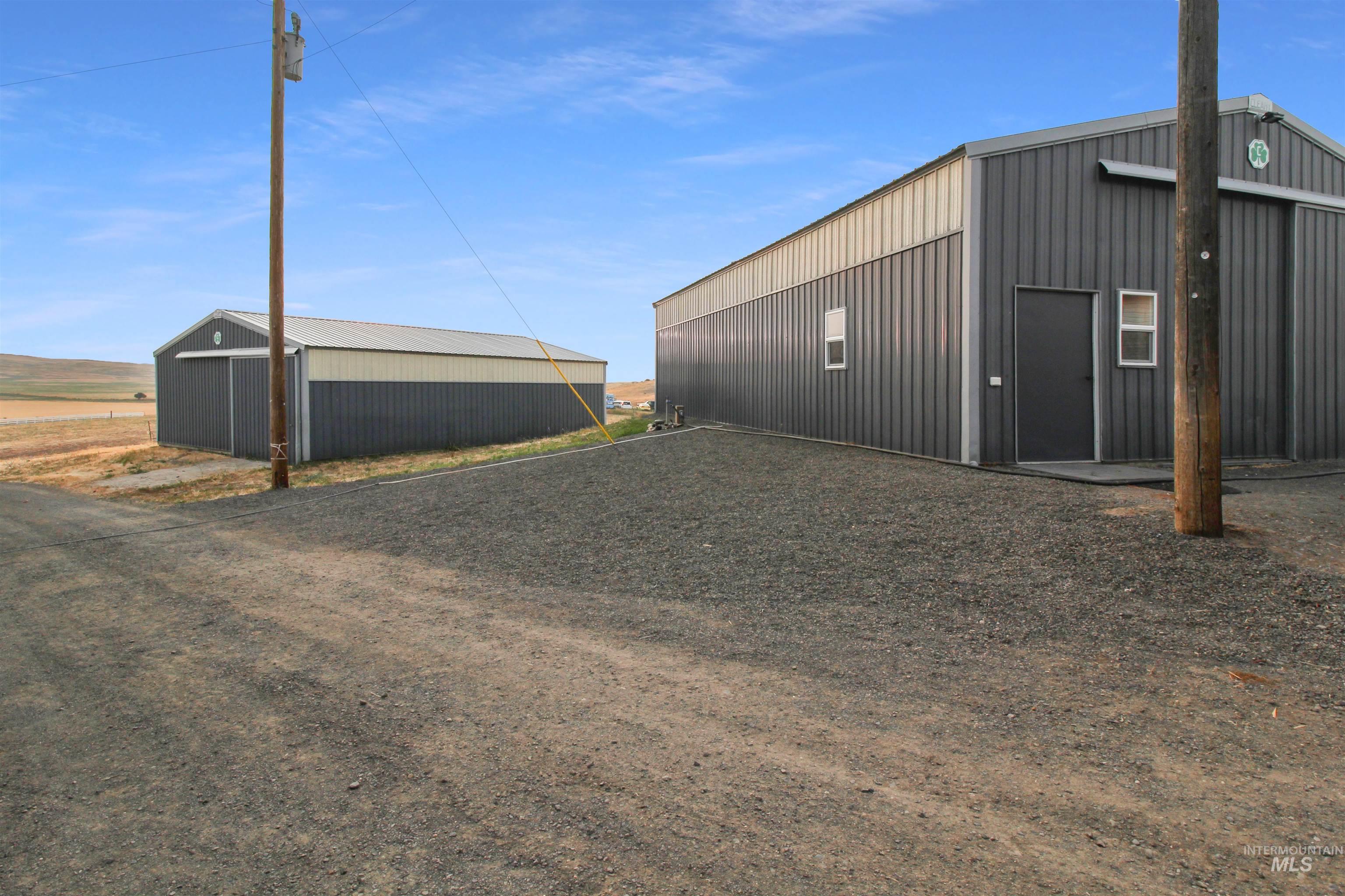 2469 Hague Road Midvale, ID 83645 - Photo 26 of 50 Two metal buildings with gray and beige siding