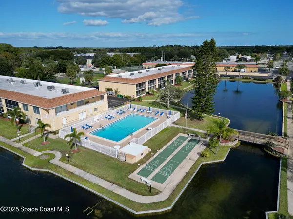 an aerial view of a house with a big yard