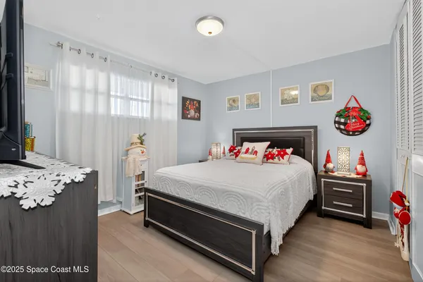 a bed sitting in a bedroom next to a window