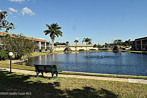 a view of a swimming pool with outdoor seating