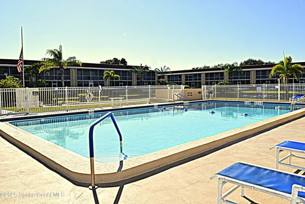 a view of a swimming pool with a lounge chairs