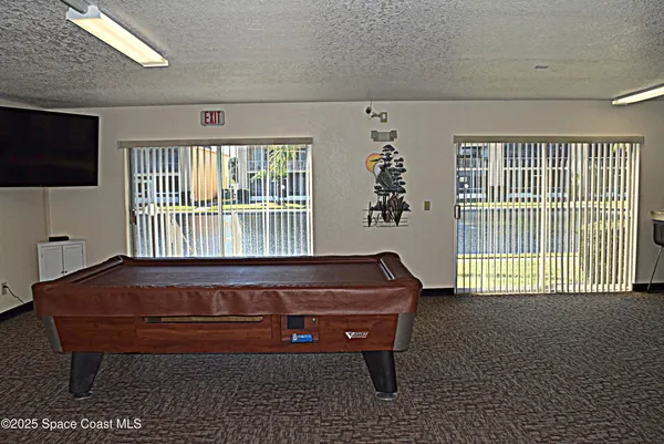 a sitting area with couch and wooden floor