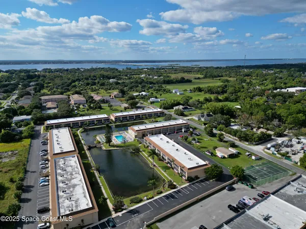 an aerial view of a residential houses with outdoor space