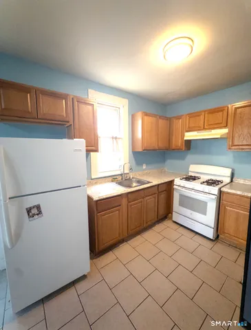 a kitchen with a cabinets and white appliances