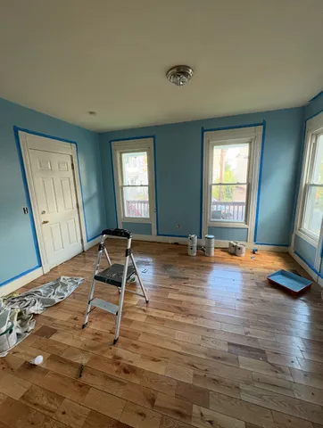 a room with wooden floor and pool table