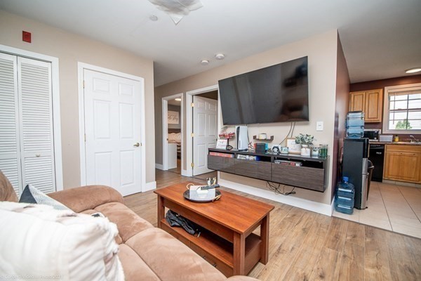 303 Eagle Street, Unit D Fall River, MA 02721 - Photo 11 of 24 a living room with furniture and a flat screen tv