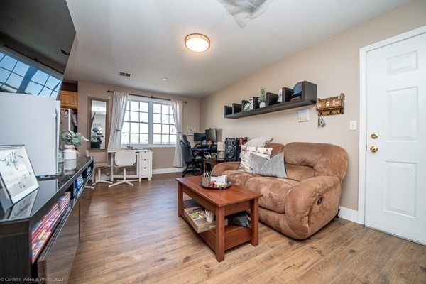 303 Eagle Street, Unit D Fall River, MA 02721 - Photo 12 of 24 a living room with furniture and a wooden floor