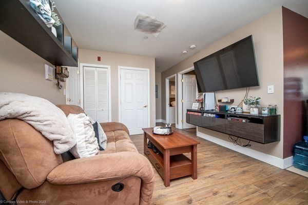 303 Eagle Street, Unit D Fall River, MA 02721 - Photo 14 of 24 a living room with furniture and a wooden floor