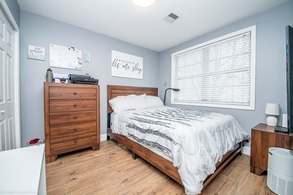 303 Eagle Street, Unit D Fall River, MA 02721 - Photo 15 of 24 a bedroom with a bed and a window