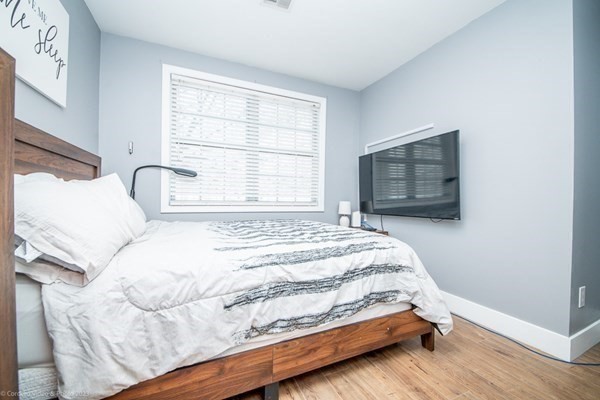 303 Eagle Street, Unit D Fall River, MA 02721 - Photo 16 of 24 a bedroom with a bed and a window