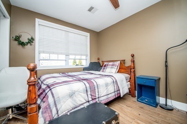 303 Eagle Street, Unit D Fall River, MA 02721 - Photo 17 of 24 a bedroom with bed and wooden floor