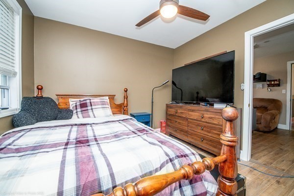 303 Eagle Street, Unit D Fall River, MA 02721 - Photo 18 of 24 a bedroom with a bed and a flat screen tv