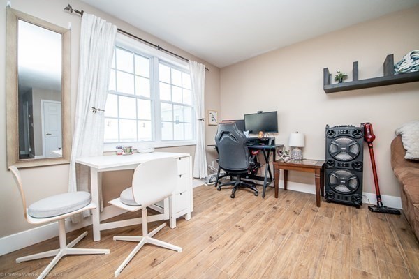 303 Eagle Street, Unit D Fall River, MA 02721 - Photo 19 of 24 a view of a workspace with furniture and a window