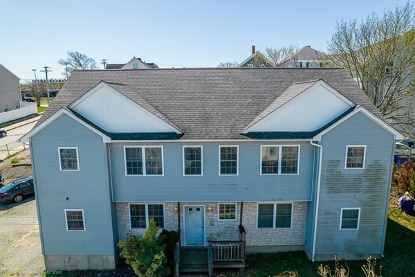 303 Eagle Street, Unit D Fall River, MA 02721 - Photo 2 of 24 a aerial view of a house with a yard and balcony