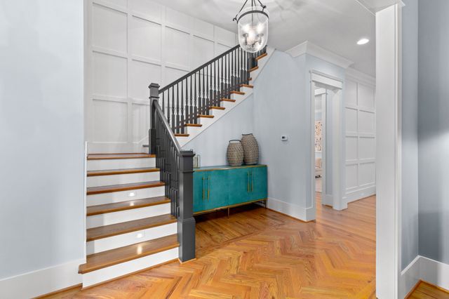 a view of entryway and hall with wooden floor