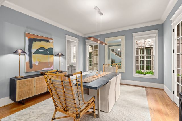 a dining room with furniture a chandelier and wooden floor