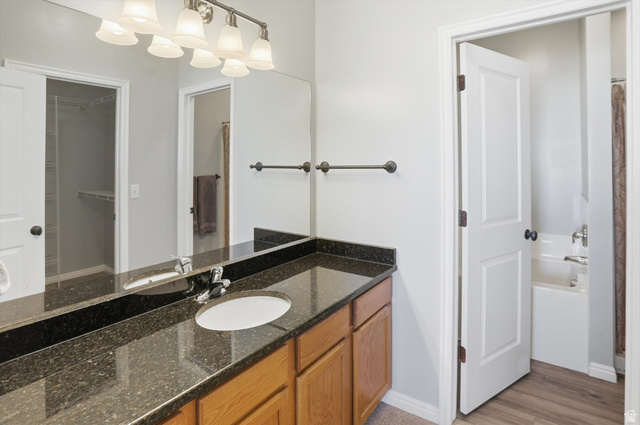 14820 175 East Draper, UT 84020 - Photo 13 of 39 Full bath with vanity, a bath, a shower with curtain, a walk in closet, and light wood-type flooring