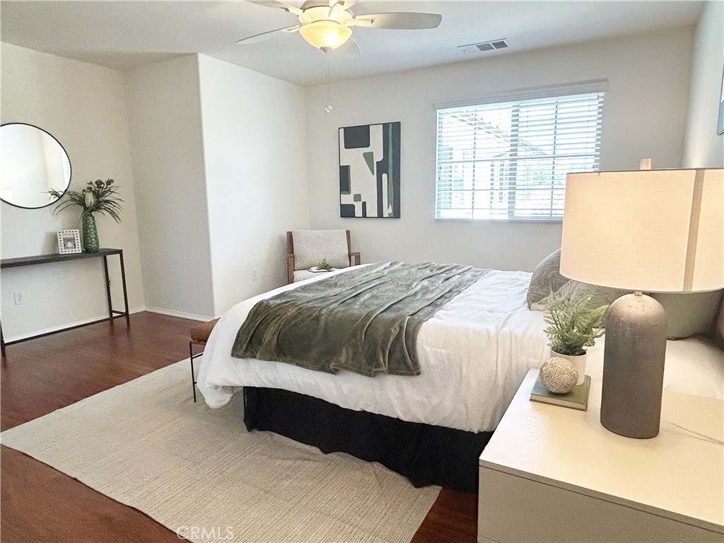 135 Silverado Irvine, CA 92618 - Photo 11 of 23 a bedroom with a bed and dresser with mirror