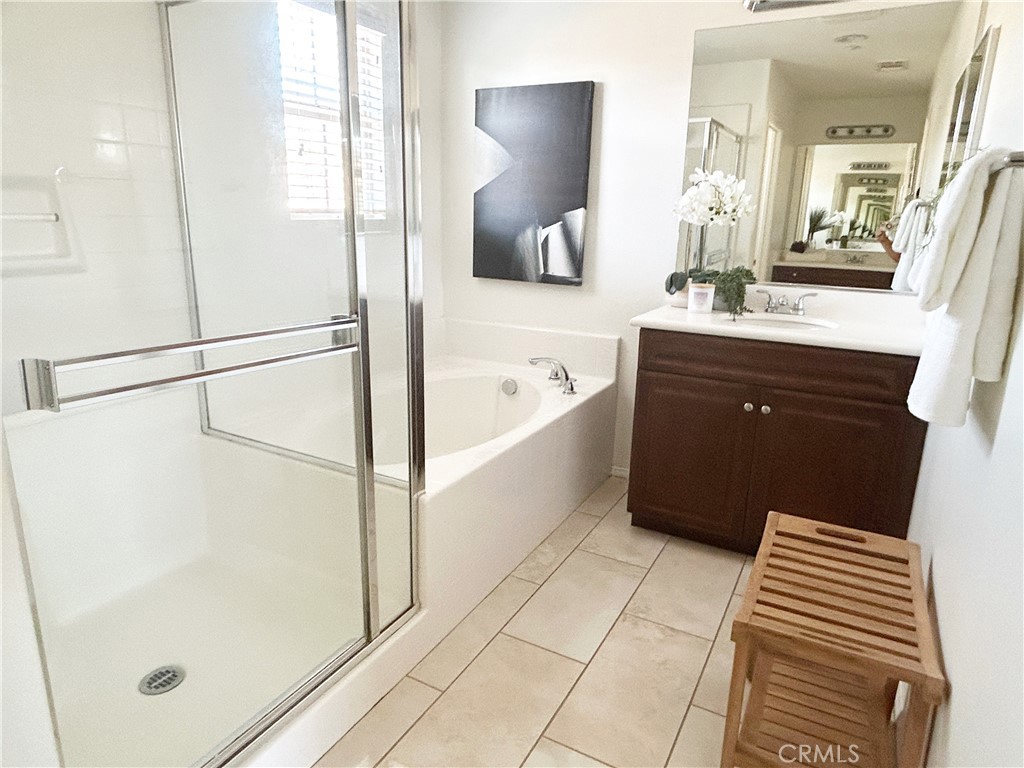 135 Silverado Irvine, CA 92618 - Photo 12 of 23 a bathroom with a tub sink and mirror