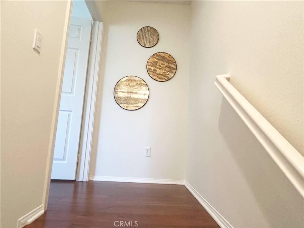 135 Silverado Irvine, CA 92618 - Photo 14 of 23 a view of a hallway with wooden floor