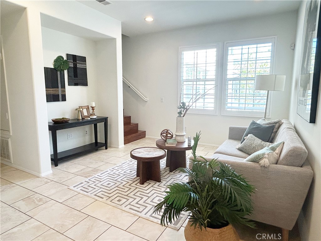 135 Silverado Irvine, CA 92618 - Photo 2 of 23 a living room with furniture and a potted plant