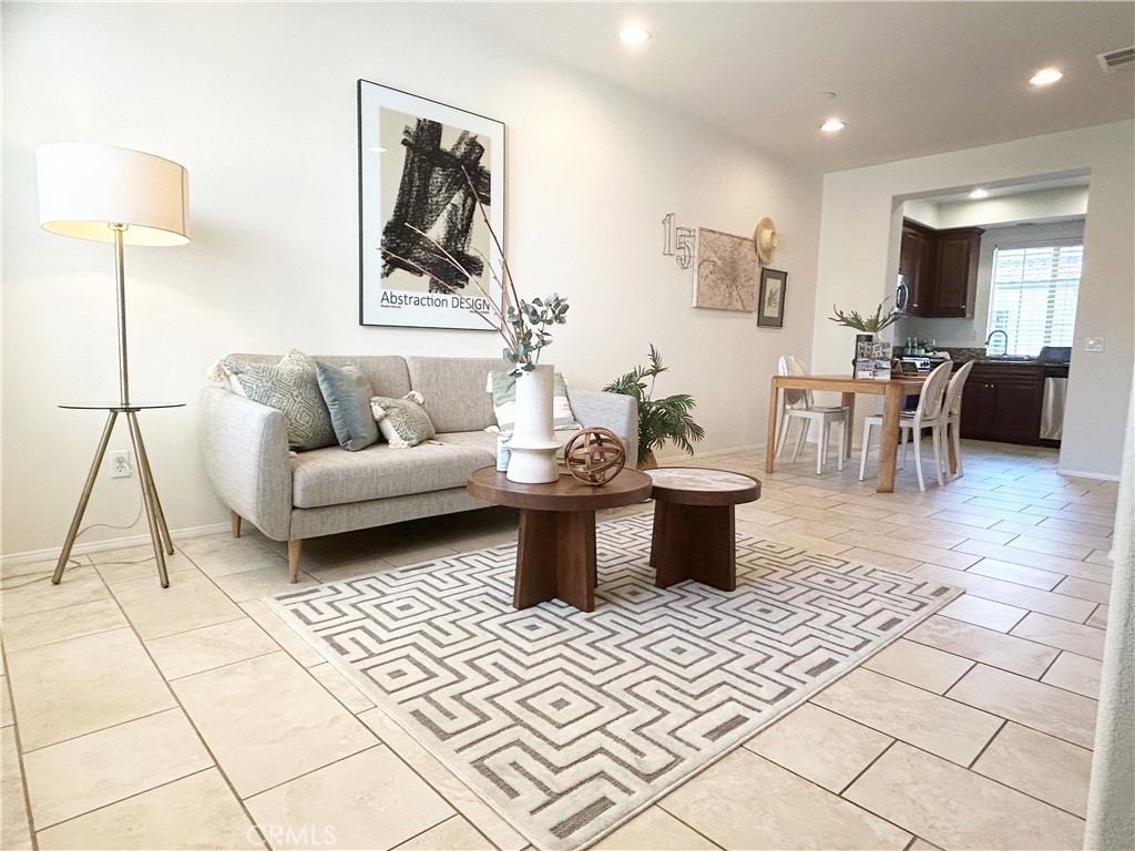 135 Silverado Irvine, CA 92618 - Photo 3 of 23 a living room with furniture a rug and a table