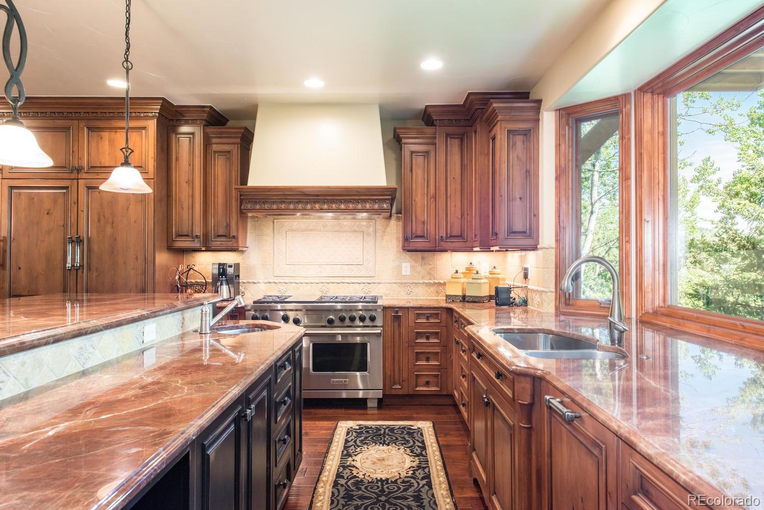 45 West Ranch Trail Morrison, CO 80465 - Photo 11 of 35 a kitchen with stainless steel appliances granite countertop sink stove top oven and cabinets